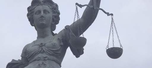 Liberty statue holding justice scales